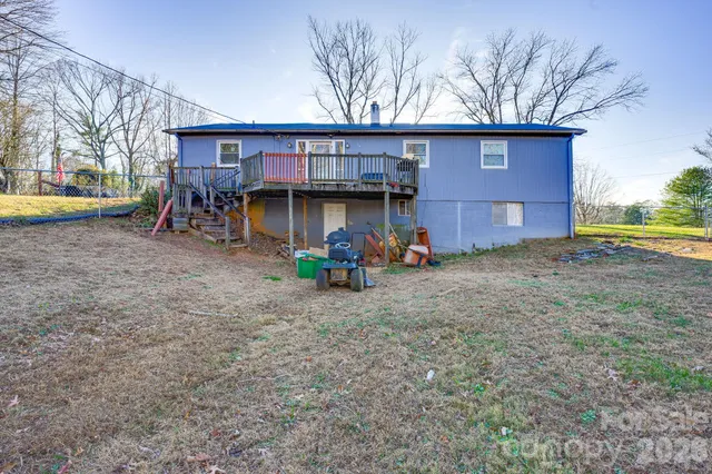 a view of a house with a yard and sitting area