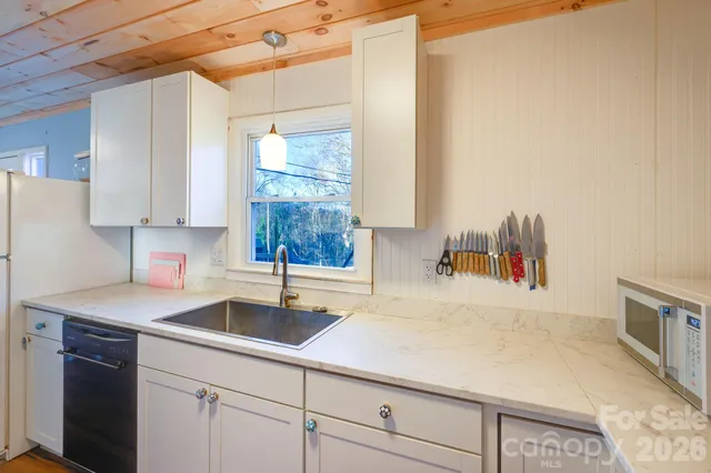 a view of a hallway with furniture and wooden floor