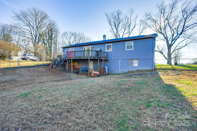 a view of a house with a yard and sitting area
