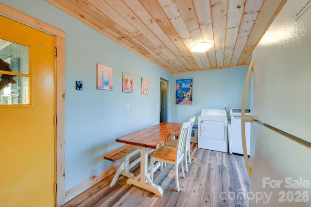 a dining room with furniture and wooden floor