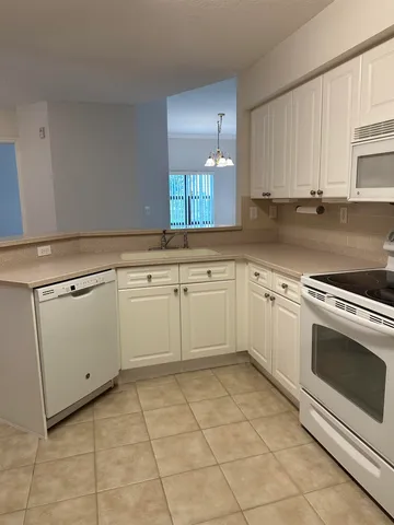 a kitchen that has a sink and a stove