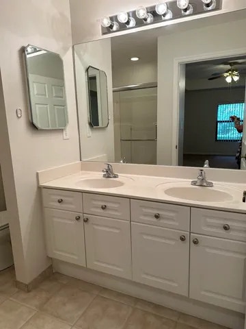 a bathroom with a glass shower door