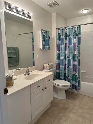 a view of two trees in a yard