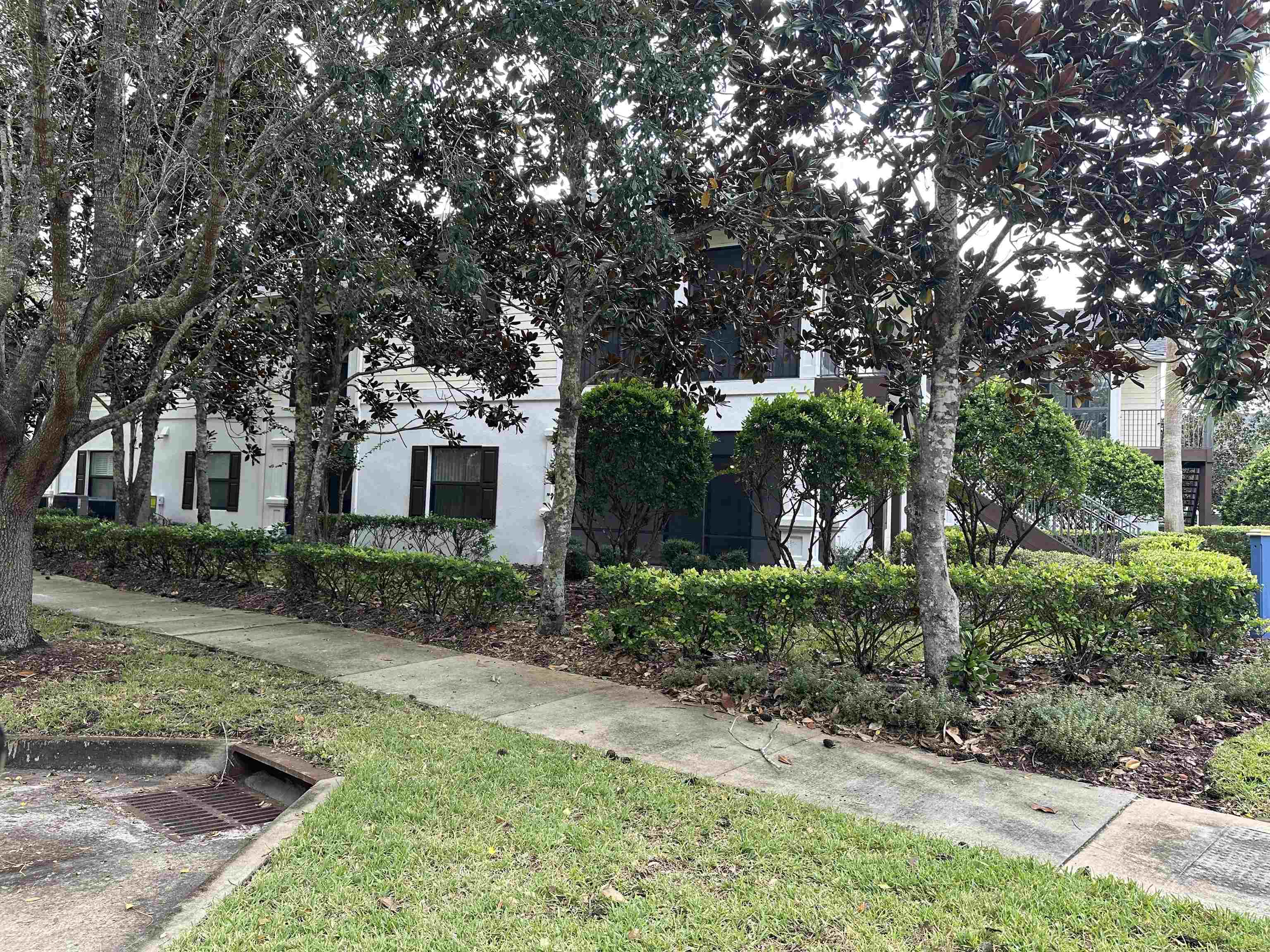 116 Laurel Wood Way, Unit 101 St. Augustine, FL 32086 - Photo 3 of 30 a front view of a house with a yard and potted plants