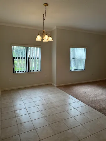 a view of a livingroom with a chandelier and windows