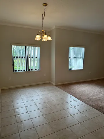 a view of a livingroom with a chandelier and windows