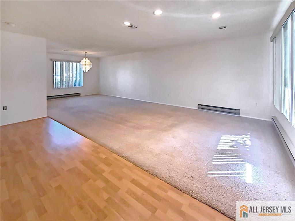 742A Pompton Road, Unit A Monroe Township, NJ 08831 - Photo 5 of 23 wooden floor in an empty room with a window