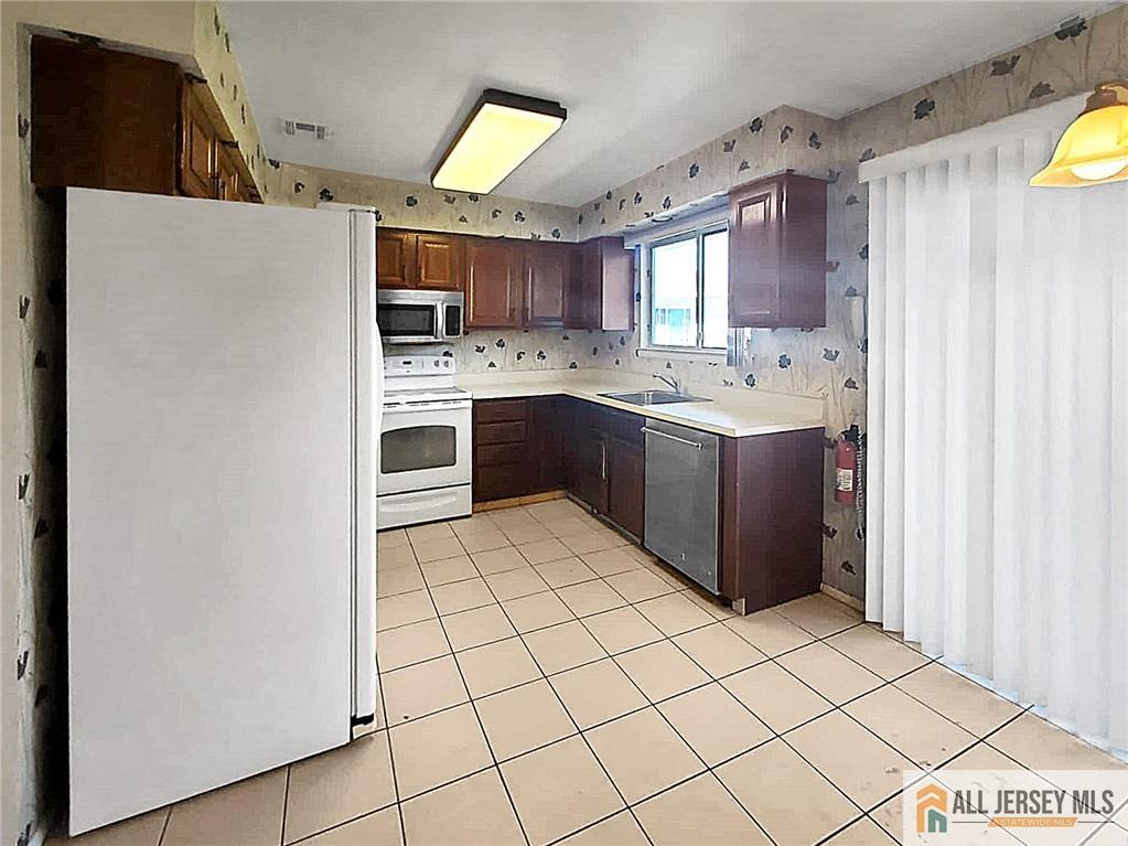 742A Pompton Road, Unit A Monroe Township, NJ 08831 - Photo 7 of 23 a kitchen with kitchen island granite countertop appliances cabinets and a sink