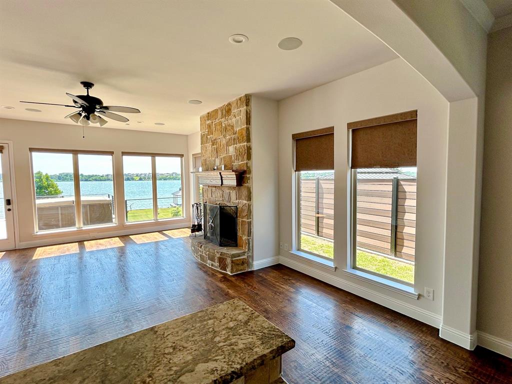 2313 Windjammer Way Rowlett, TX 75088 - Photo 4 of 38 a view of an empty room with a window and wooden floor