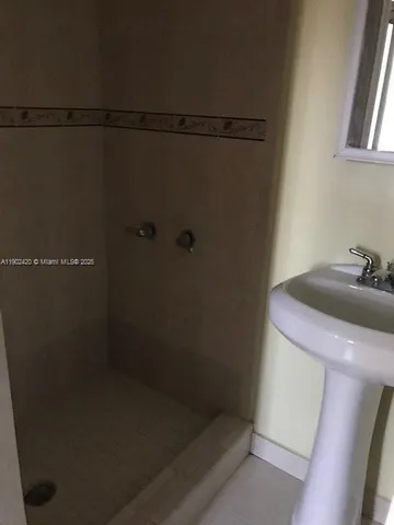 a bathroom with a shower and sink