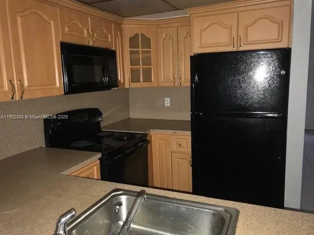 a kitchen with a refrigerator stove and microwave