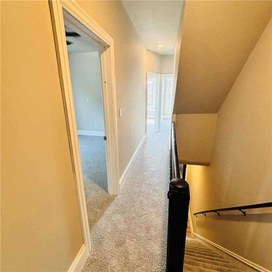 718 Linden Street Bethlehem, PA 18018 - Photo 11 of 19 A well-lit hallway with plush carpeting provides clear access to the upper level's inviting rooms.
