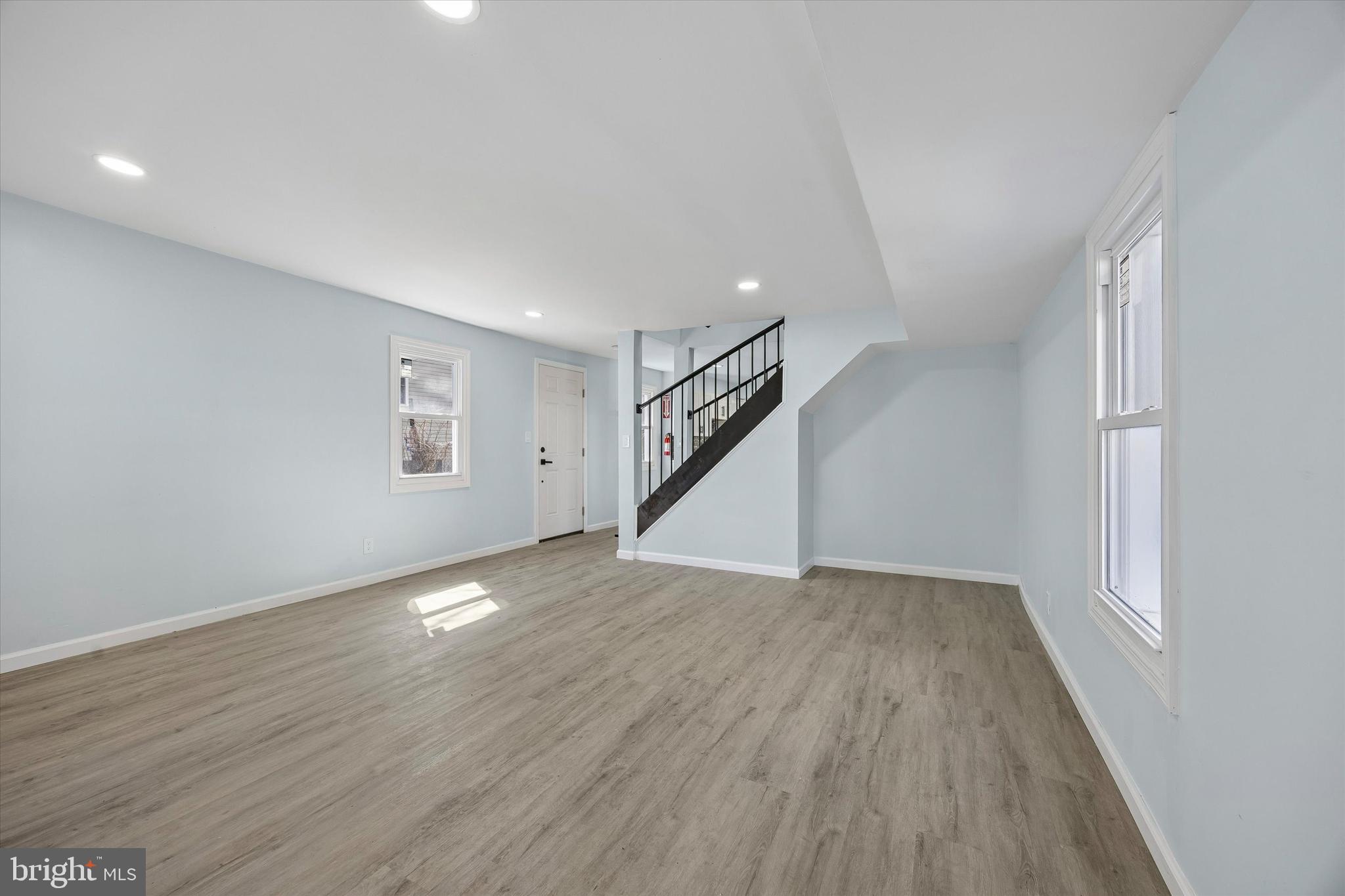 6 West Griffith Street Penns Grove, NJ 08069 - Photo 7 of 25 a view of an empty room with wooden floor and stairs
