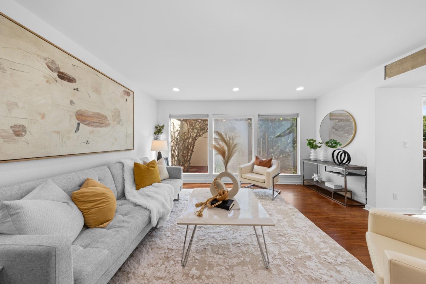 a living room with furniture and wooden floor
