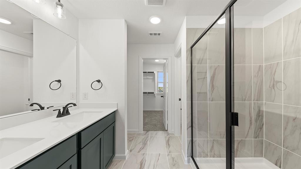 2524 YO Rnch Road Anna, TX 75409 - Photo 17 of 30 a bathroom with a shower sink and mirror