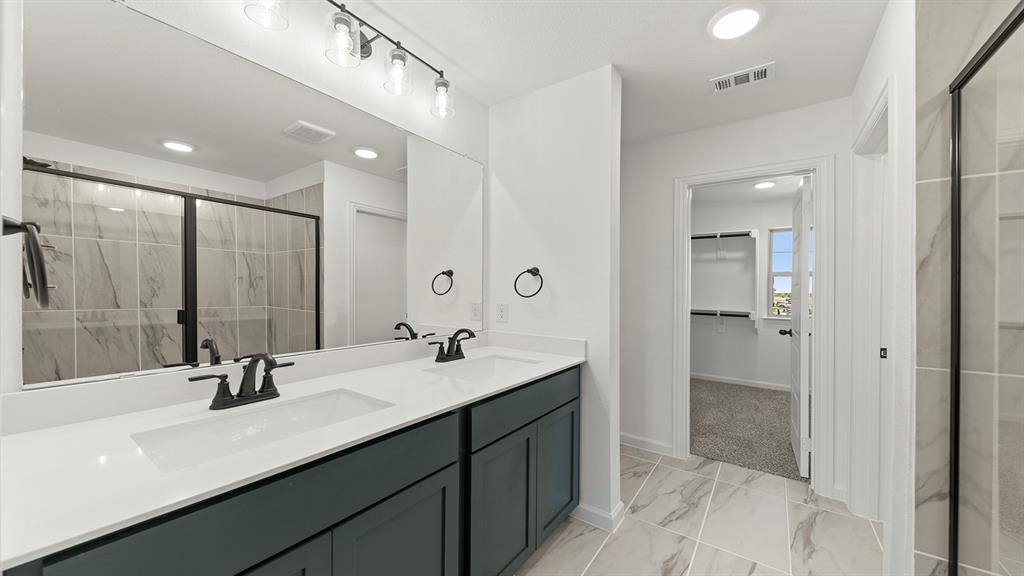 2524 YO Rnch Road Anna, TX 75409 - Photo 18 of 30 a bathroom with a double vanity sink a mirror and shower
