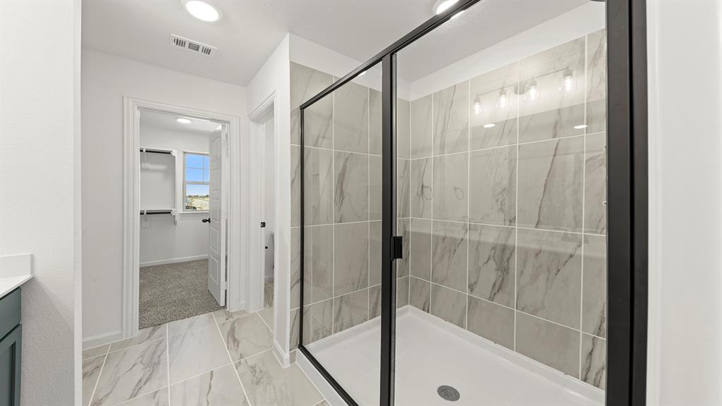 2524 YO Rnch Road Anna, TX 75409 - Photo 19 of 30 a bathroom with a glass shower door