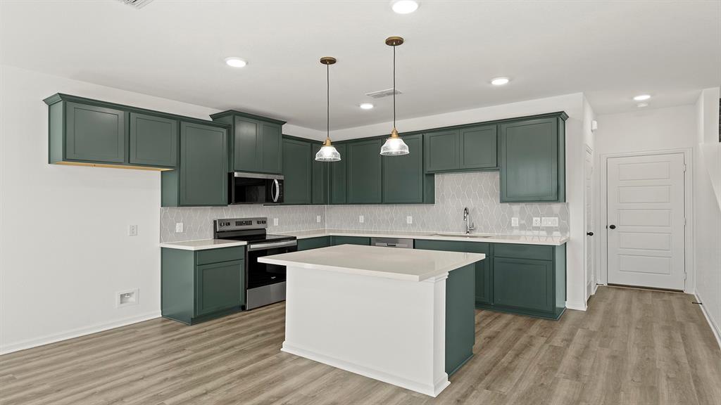 2524 YO Rnch Road Anna, TX 75409 - Photo 5 of 30 a kitchen with stainless steel appliances granite countertop a sink a stove and a wooden floors