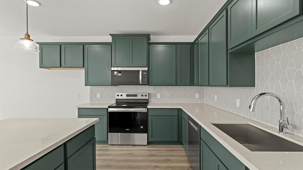 2524 YO Rnch Road Anna, TX 75409 - Photo 6 of 30 a kitchen with a sink cabinets and stainless steel appliances
