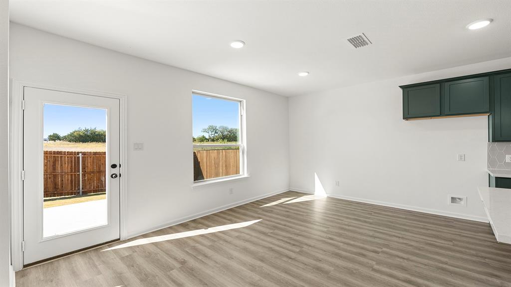 2524 YO Rnch Road Anna, TX 75409 - Photo 7 of 30 a view of an empty room with wooden floor and a window