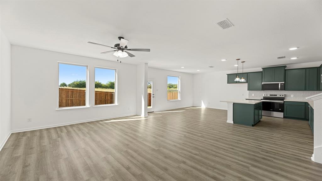 2524 YO Rnch Road Anna, TX 75409 - Photo 9 of 30 a view of kitchen with a sink dishwasher a kitchen island with wooden cabinets and floor to ceiling window