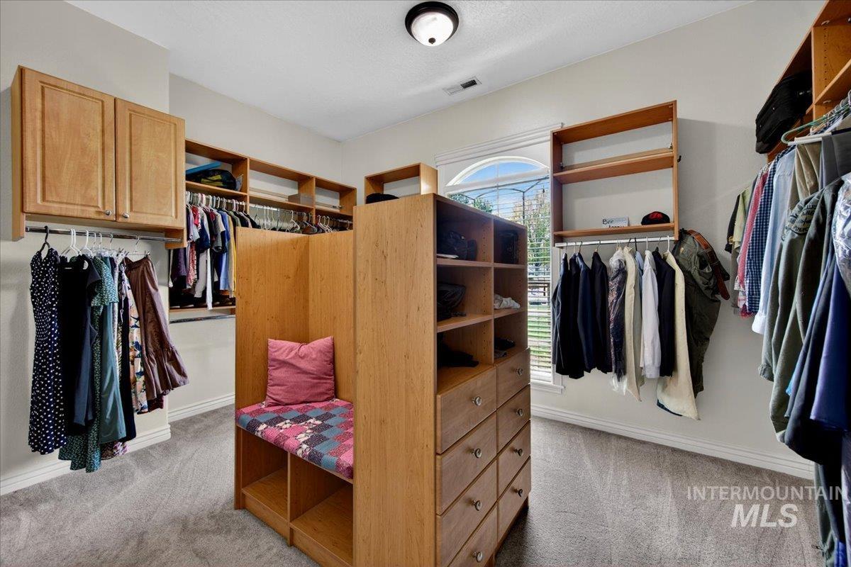 414 East Shafer View Drive Meridian, ID 83642 - Photo 24 of 50 Expansive custom closet featuring extensive built-in wooden shelving, multiple hanging rods, integrated drawer storage, and a central built-in bench, Washer/Dryer hookups for an extra laundry if so desired