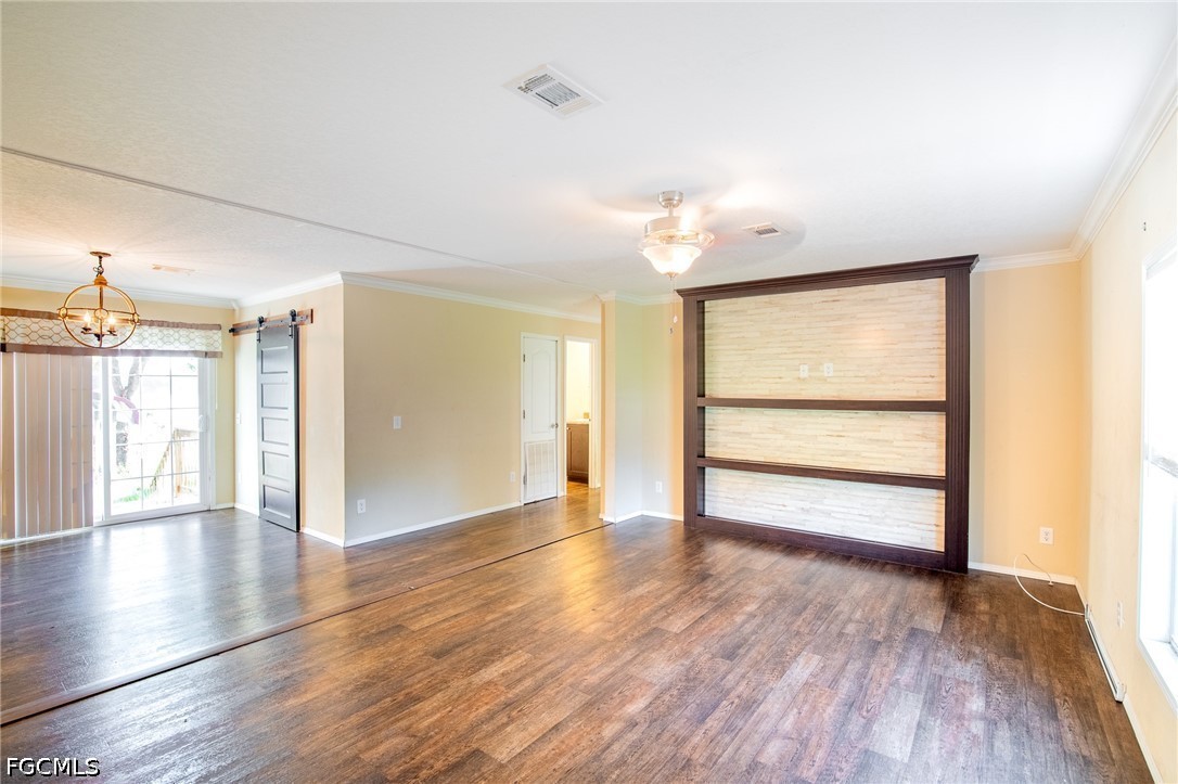 1580 Ridgdill Road Clewiston, FL 33440 - Photo 13 of 30 a view of an empty room with a window and wooden floor