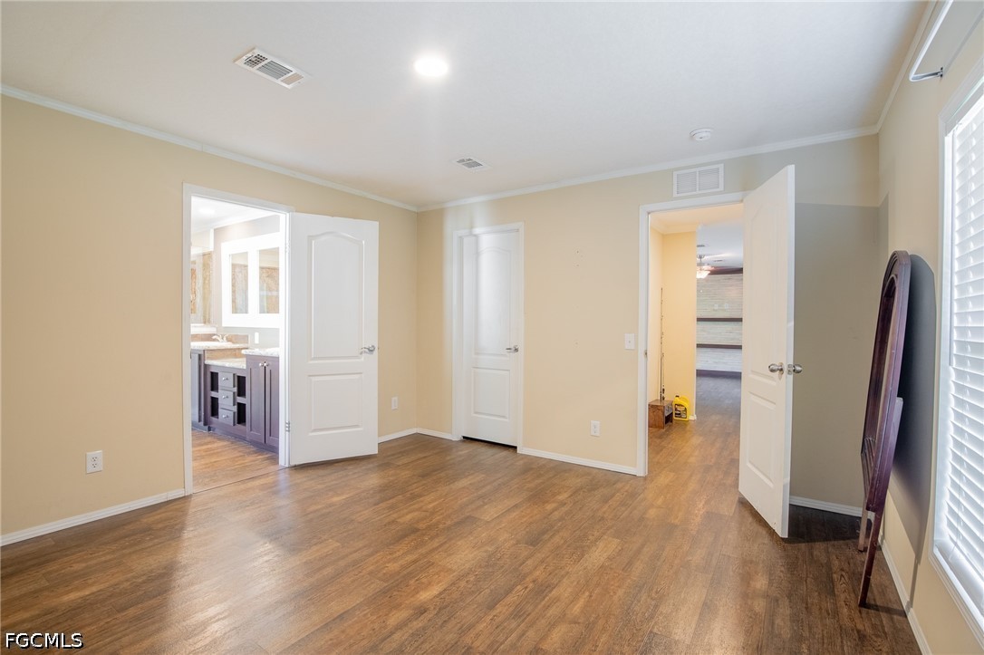 1580 Ridgdill Road Clewiston, FL 33440 - Photo 15 of 30 wooden floor in an empty room with a window