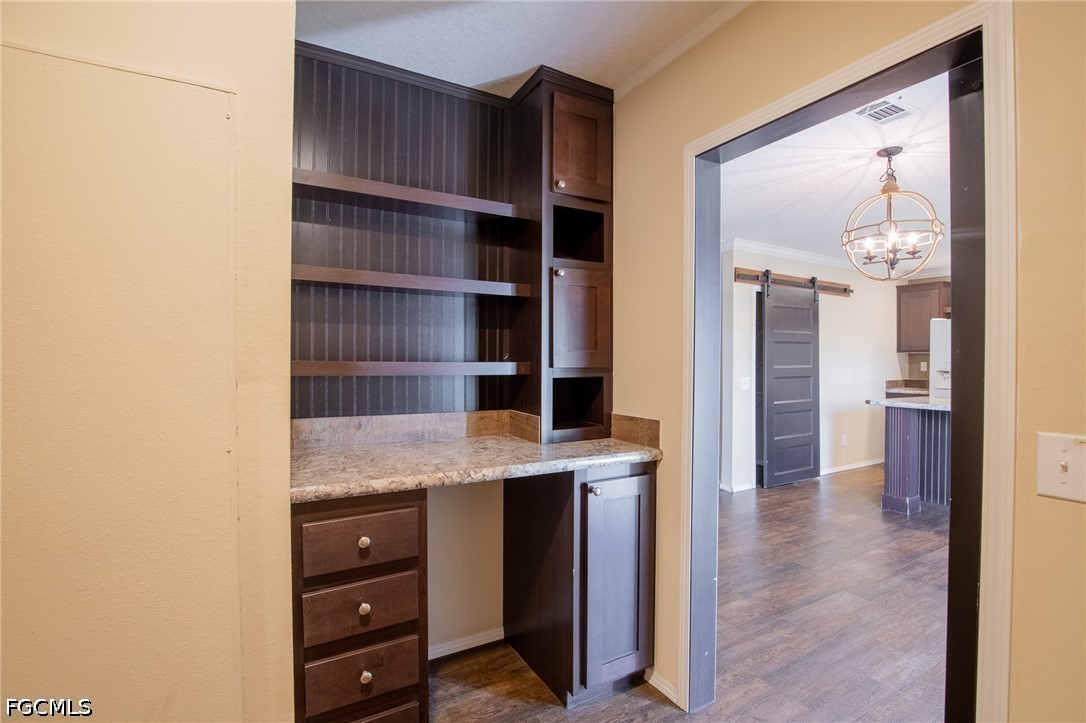 1580 Ridgdill Road Clewiston, FL 33440 - Photo 21 of 30 a view of workspace with wooden floor and cabinet