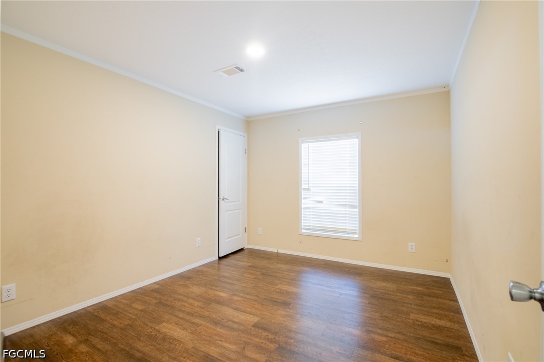 1580 Ridgdill Road Clewiston, FL 33440 - Photo 23 of 30 an empty room with wooden floor and window
