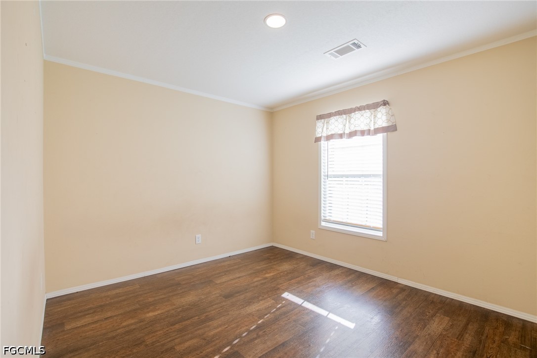 1580 Ridgdill Road Clewiston, FL 33440 - Photo 24 of 30 an empty room with wooden floor and windows