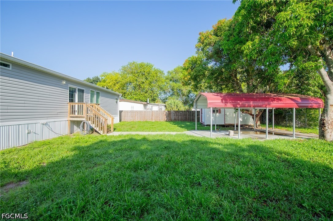 1580 Ridgdill Road Clewiston, FL 33440 - Photo 26 of 30 a backyard of a house with table and chairs