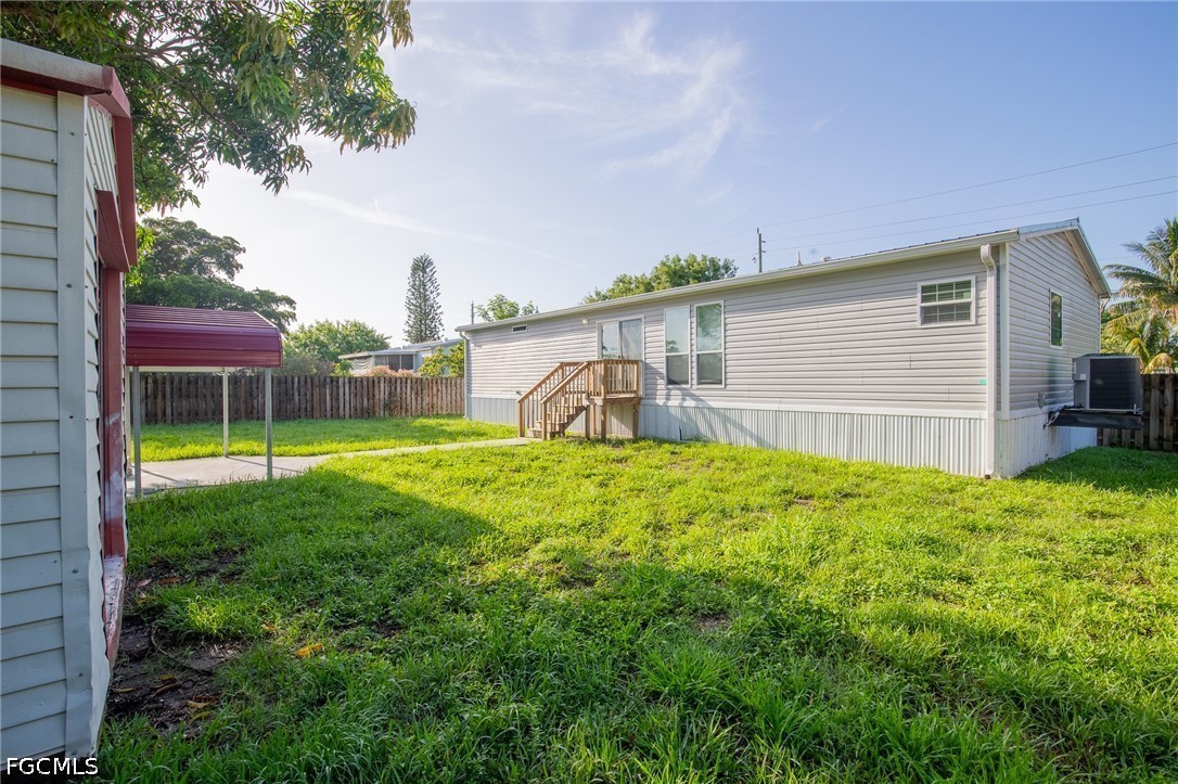 1580 Ridgdill Road Clewiston, FL 33440 - Photo 28 of 30 a backyard of a house with table and chairs
