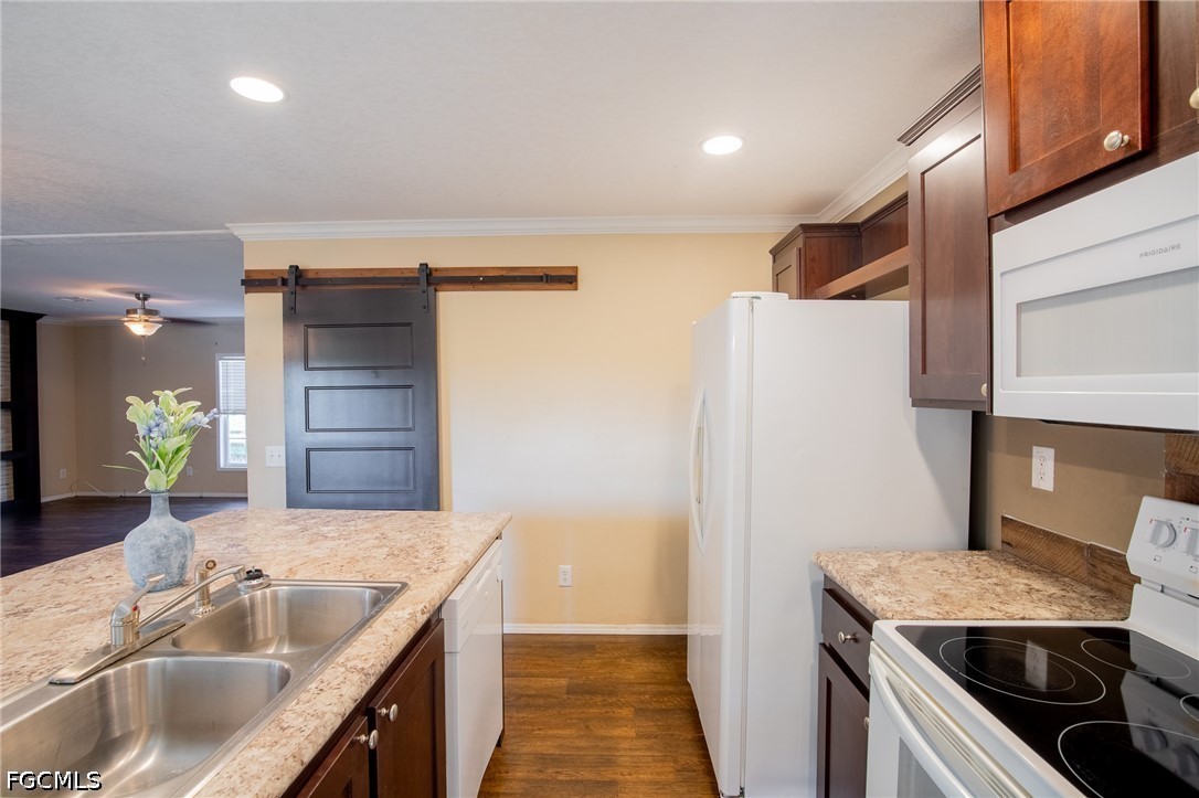 1580 Ridgdill Road Clewiston, FL 33440 - Photo 8 of 30 a kitchen with granite countertop a sink and a refrigerator