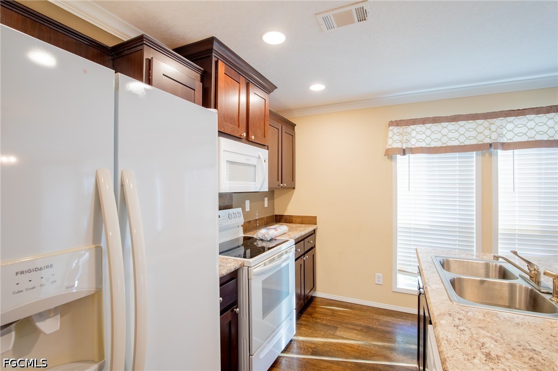 1580 Ridgdill Road Clewiston, FL 33440 - Photo 10 of 30 a kitchen with granite countertop a sink and a refrigerator