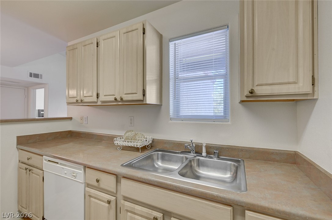 555 East Silverado Ranch Boulevard, Unit 2124 Las Vegas, NV 89183 - Photo 18 of 47 Well-appointed kitchen featuring a double basin sink, abundant cabinet storage, and functional countertops.