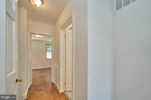 a view of a bathroom from a hallway