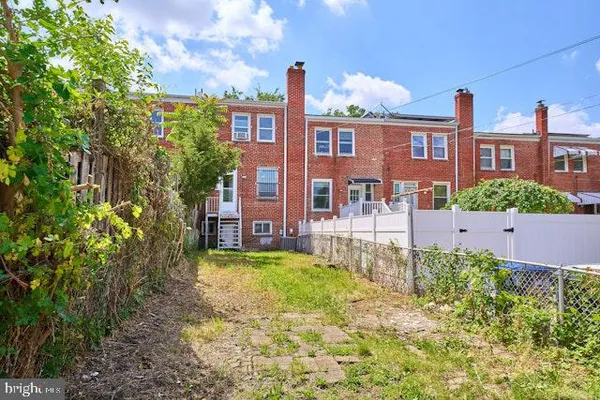 a front view of a house with a yard and fountain