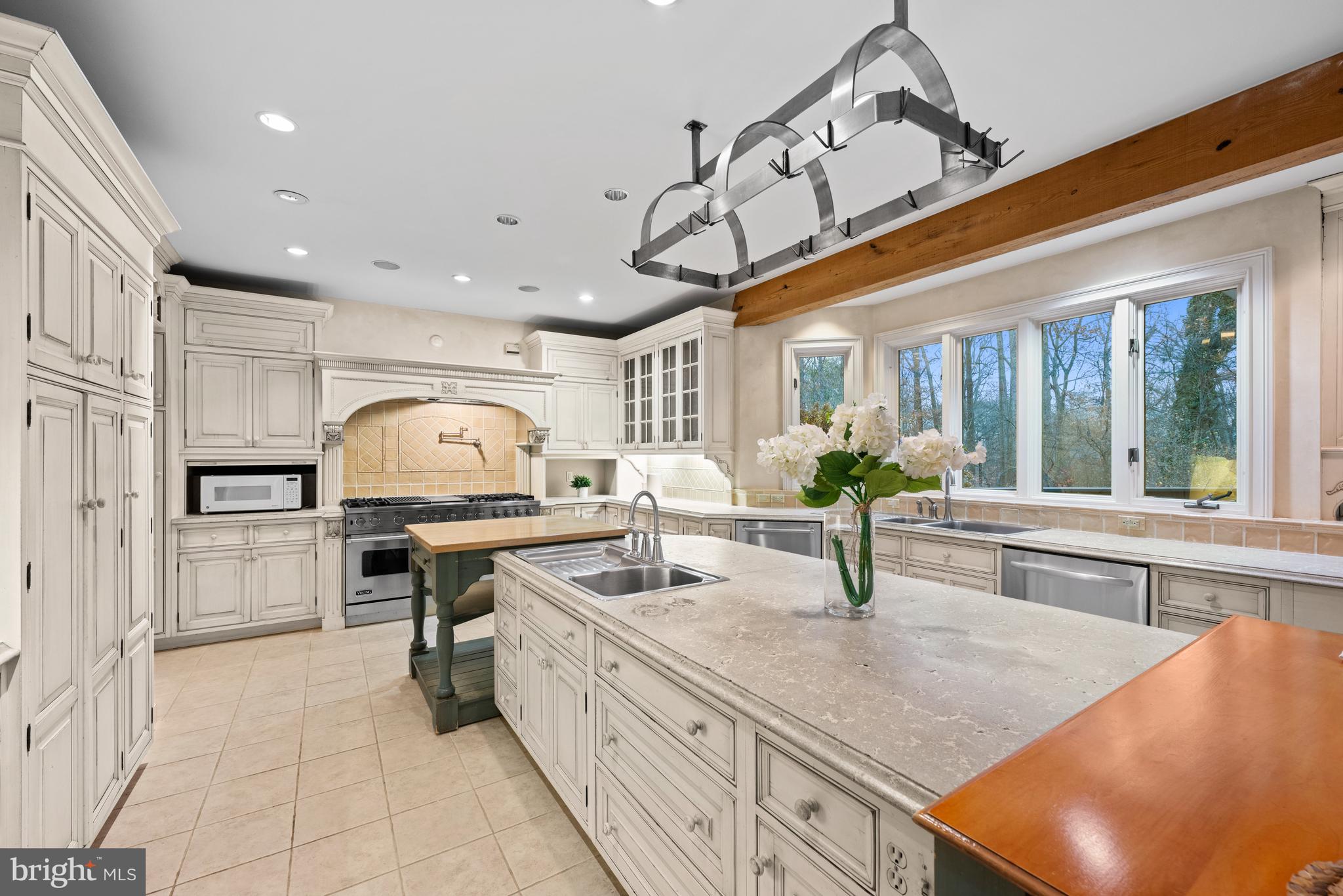 11552 Springridge Road Potomac, MD 20854 - Photo 11 of 65 a kitchen with stainless steel appliances a sink a stove and cabinets