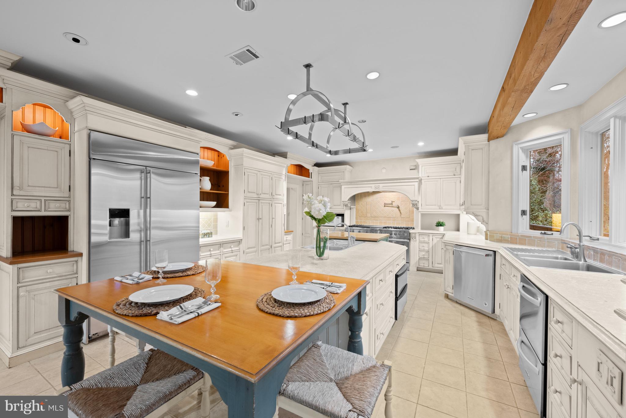 11552 Springridge Road Potomac, MD 20854 - Photo 12 of 65 a kitchen with a table chairs stove and microwave