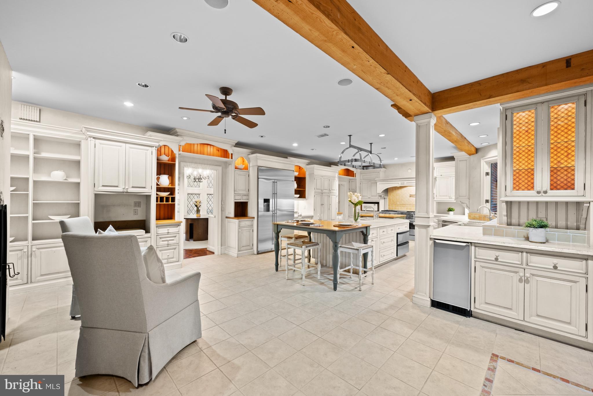 11552 Springridge Road Potomac, MD 20854 - Photo 13 of 65 a large white kitchen with a large window and furniture
