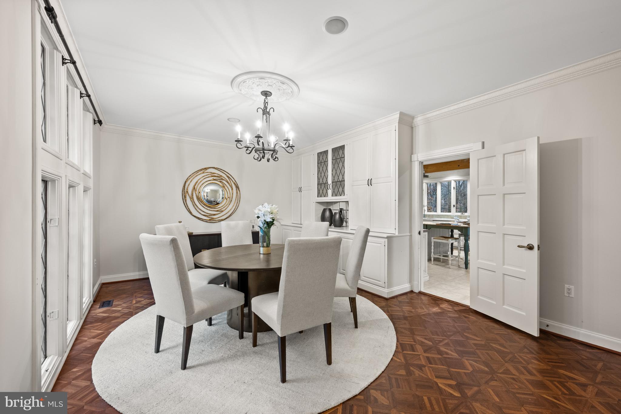 11552 Springridge Road Potomac, MD 20854 - Photo 21 of 65 a view of a dining room with furniture a chandelier and wooden floor