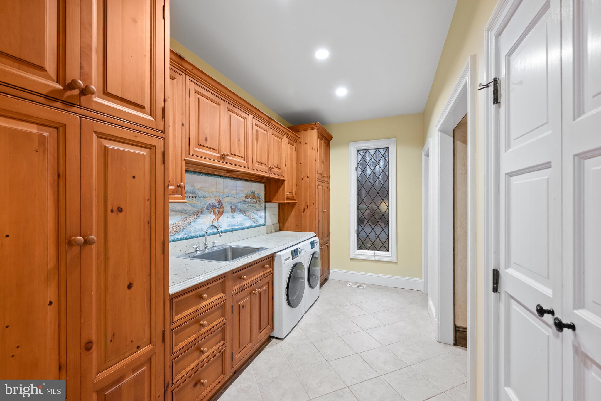 11552 Springridge Road Potomac, MD 20854 - Photo 30 of 65 a bathroom with a granite countertop double vanity and a large mirror