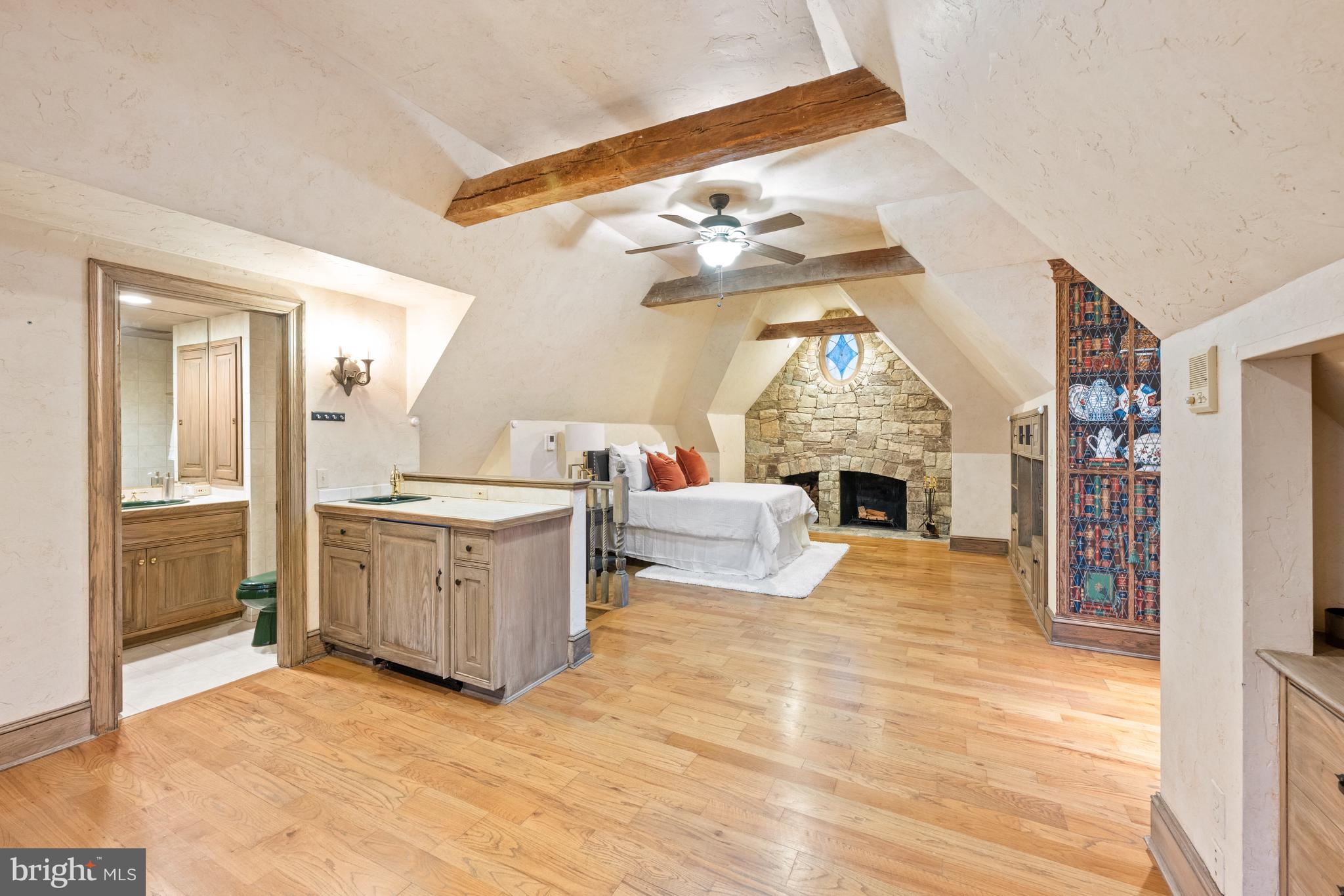 11552 Springridge Road Potomac, MD 20854 - Photo 44 of 65 a view of a livingroom with a fireplace a chandelier a wooden floor and windows
