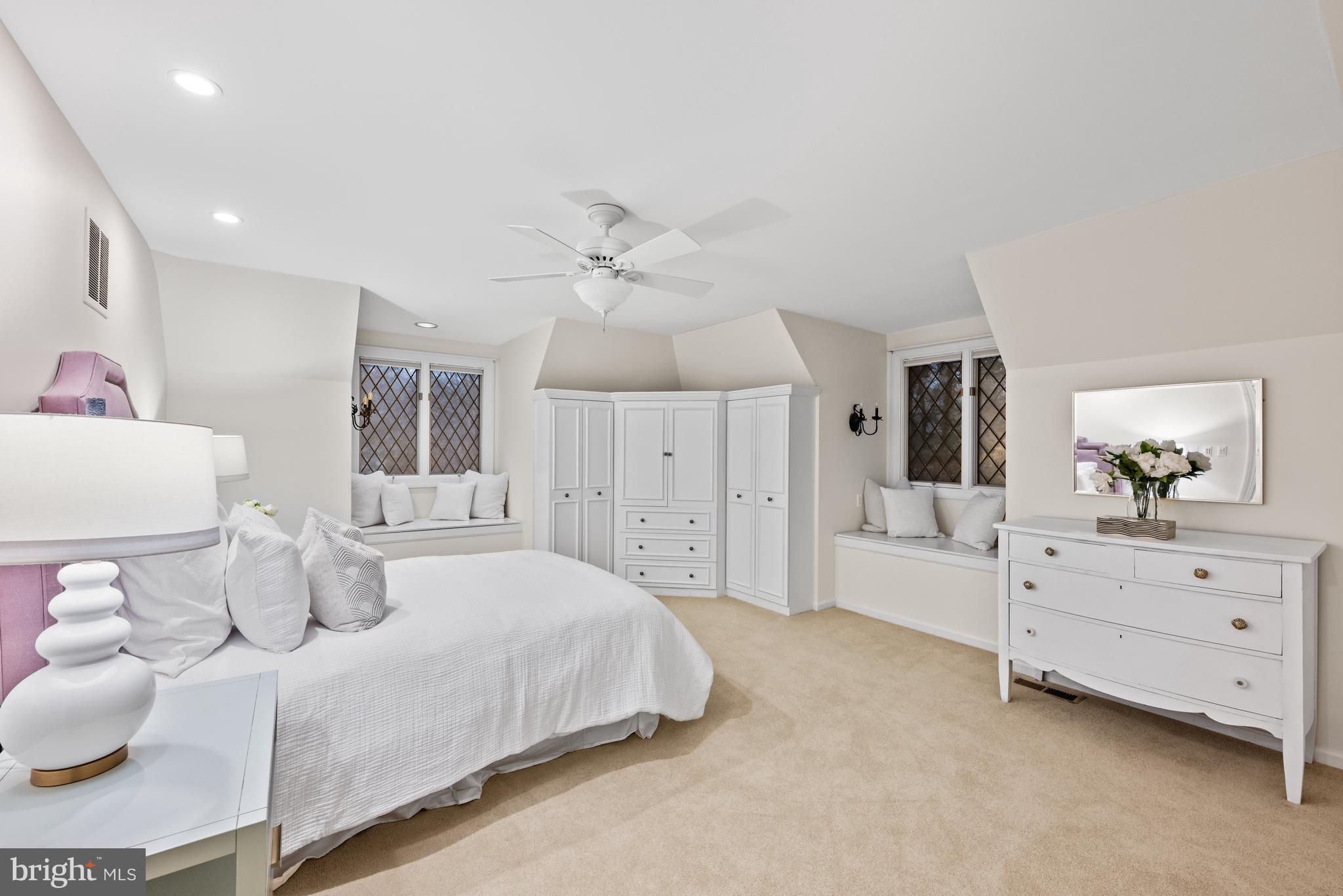 11552 Springridge Road Potomac, MD 20854 - Photo 46 of 65 a spacious bedroom with a bed and a chandelier