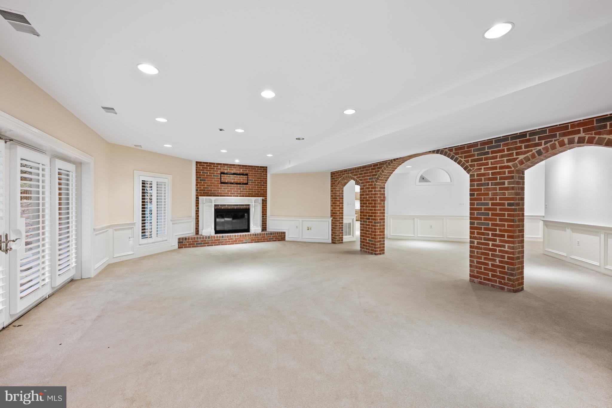 11552 Springridge Road Potomac, MD 20854 - Photo 50 of 65 an empty room with fireplace and window