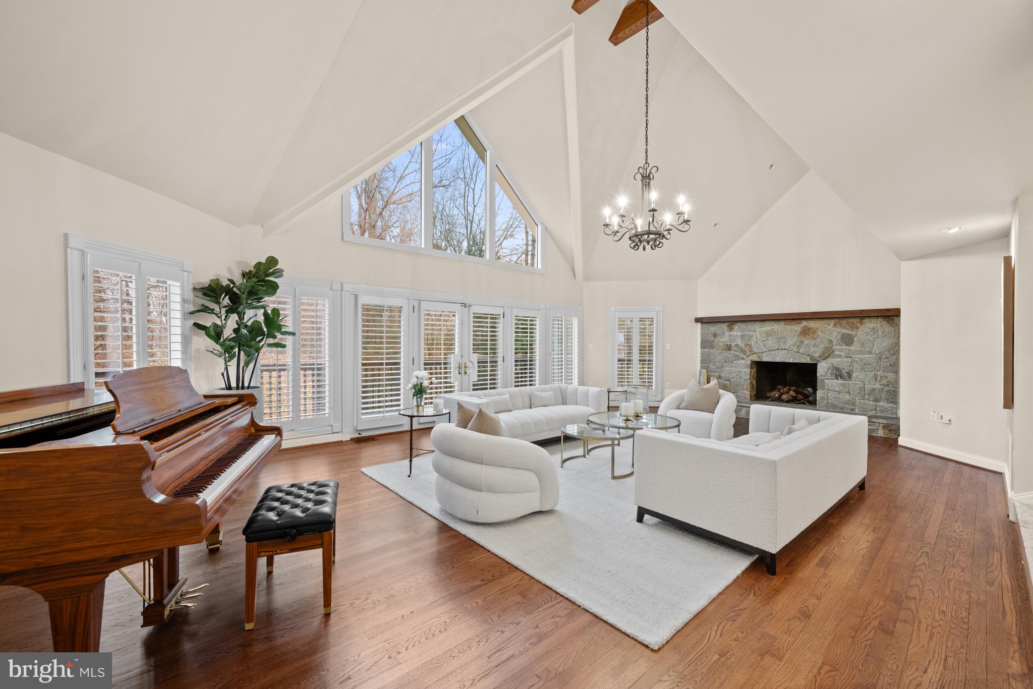 11552 Springridge Road Potomac, MD 20854 - Photo 10 of 65 a living room with furniture a fireplace and a chandelier