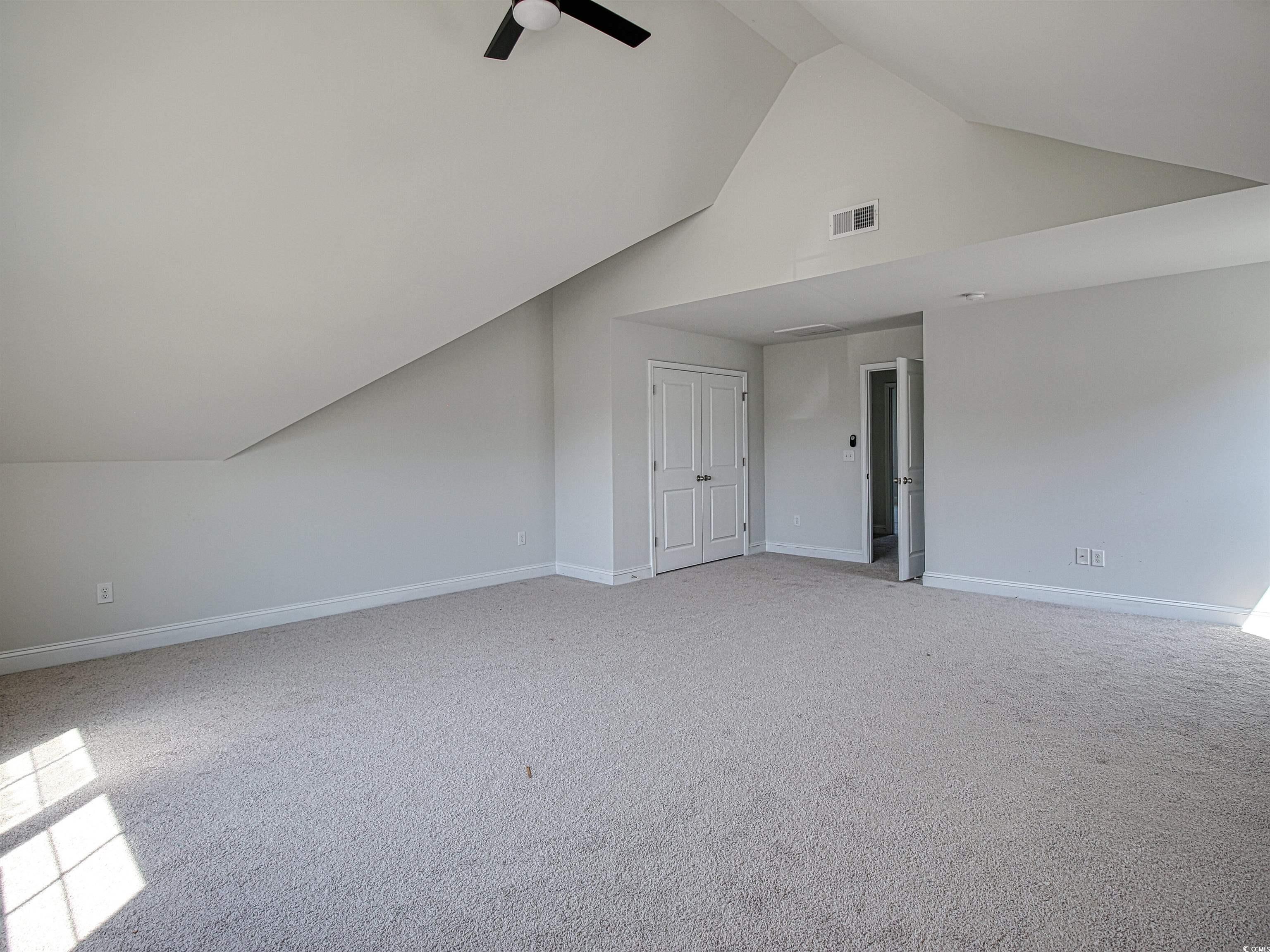 504 Patapsco Street Little River, SC 29566 - Photo 13 of 21 Bonus room with ceiling fan, light colored carpet, and high vaulted ceiling
