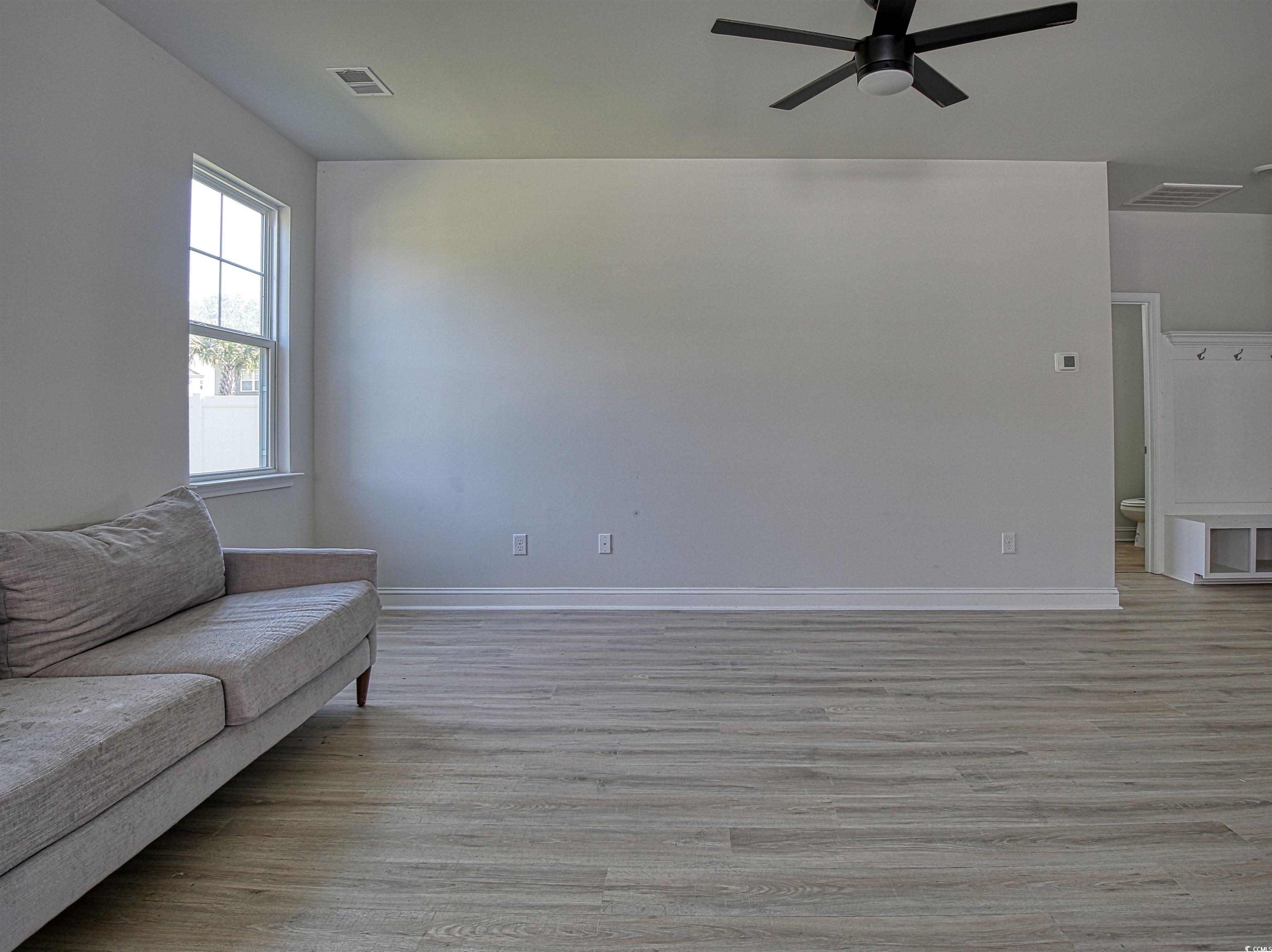 504 Patapsco Street Little River, SC 29566 - Photo 2 of 21 Living room with light wood-style flooring and ceiling fan
