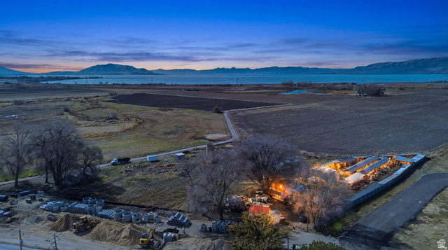 1412 South Geneva Road Orem, UT 84058 - Photo 1 of 19 Expansive rural property featuring multiple structures, cultivated land, and a body of water in the background